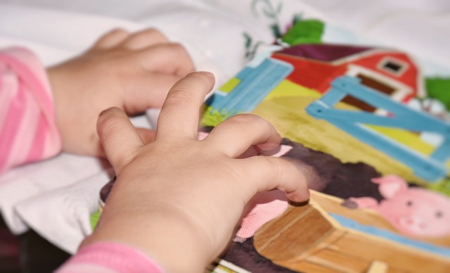 A teacher guiding a child in a pouring activity, fostering concentration and self-control.